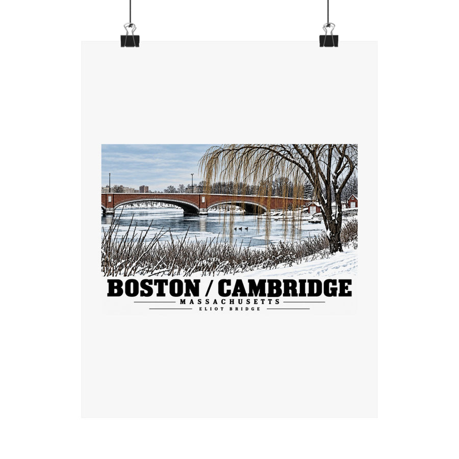 Eliot Bridge winter river view with snow and bare trees poster with Boston/Cambridge lettering hanging from two binder clips