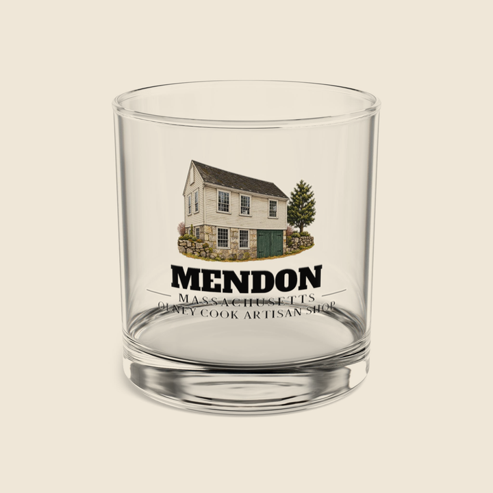 Mendon Olney Cook Artisan Shop rocks glass with colored engraving, shown on a cream background