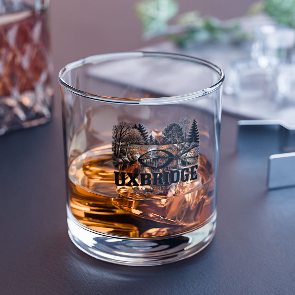Uxbridge Rice City Pond Bridge rocks glass with a drink on a table