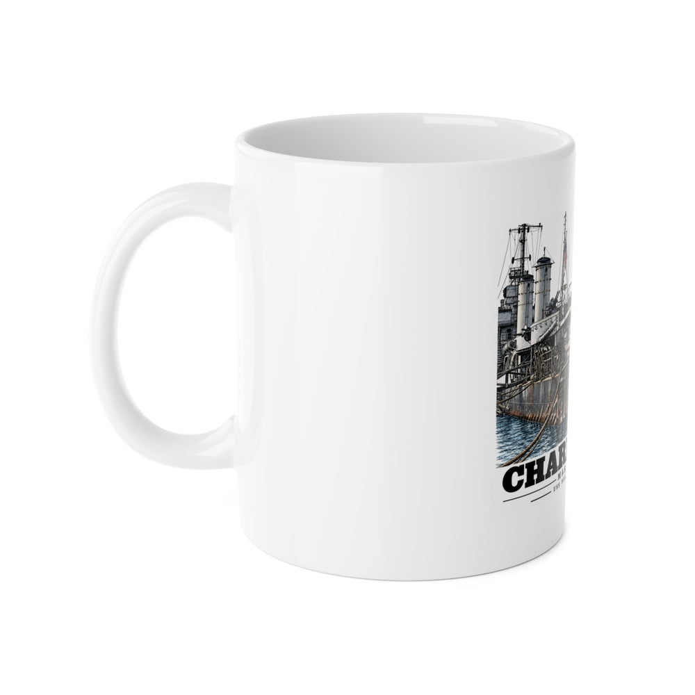 Left side of white ceramic mug showing handle and partial USS Nelson artwork