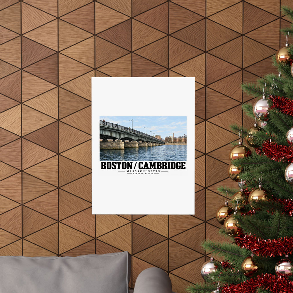 Poster with Harvard Bridge artwork and Boston/Cambridge lettering on a wood wall beside a decorated evergreen