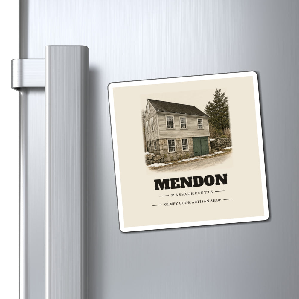 Mendon Olney Cook Artisan Shop 4 inch magnet shown on a refrigerator