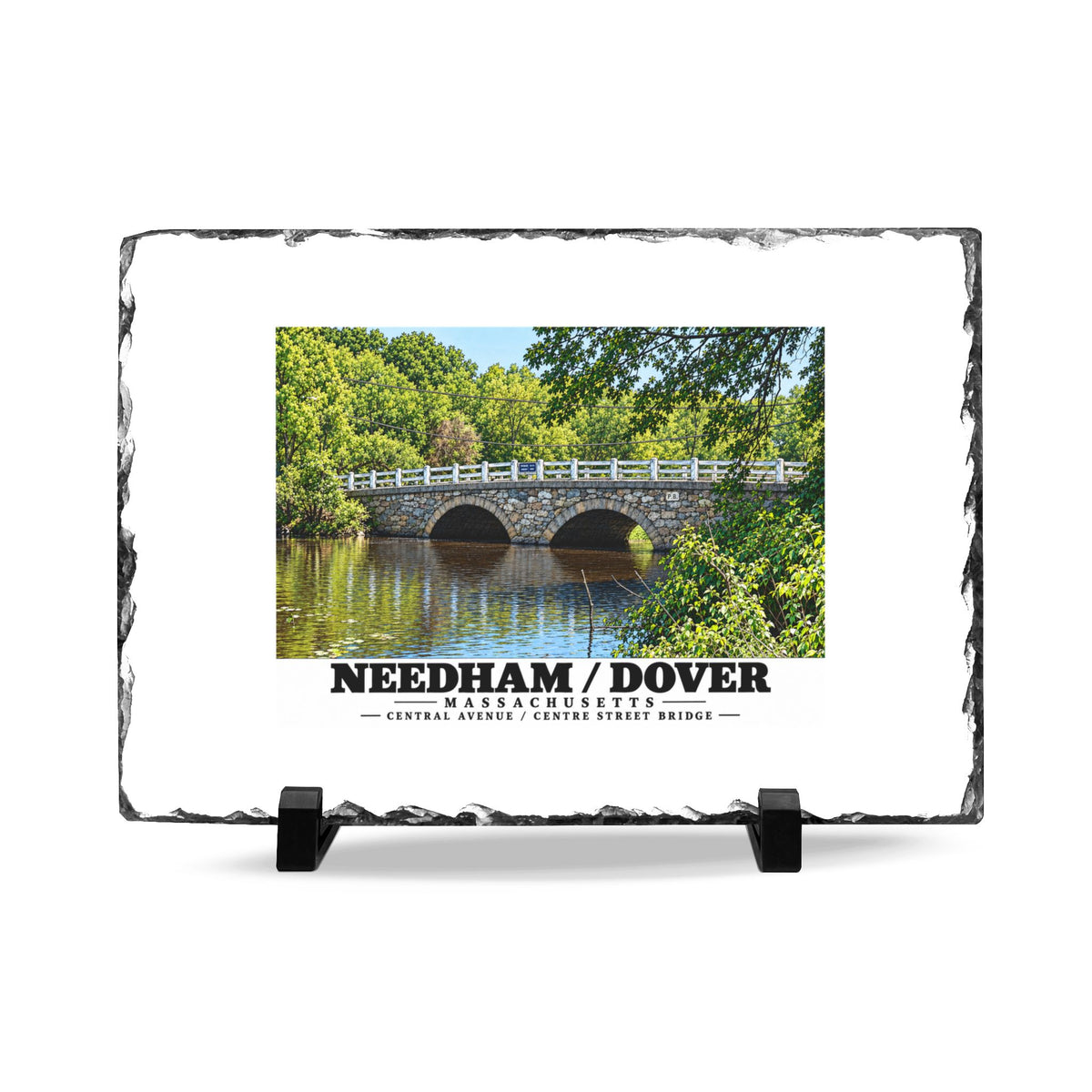 Rough-edged slate display on two black stands with Central Avenue / Centre Street Bridge stone arches and river artwork and Needham/Dover lettering