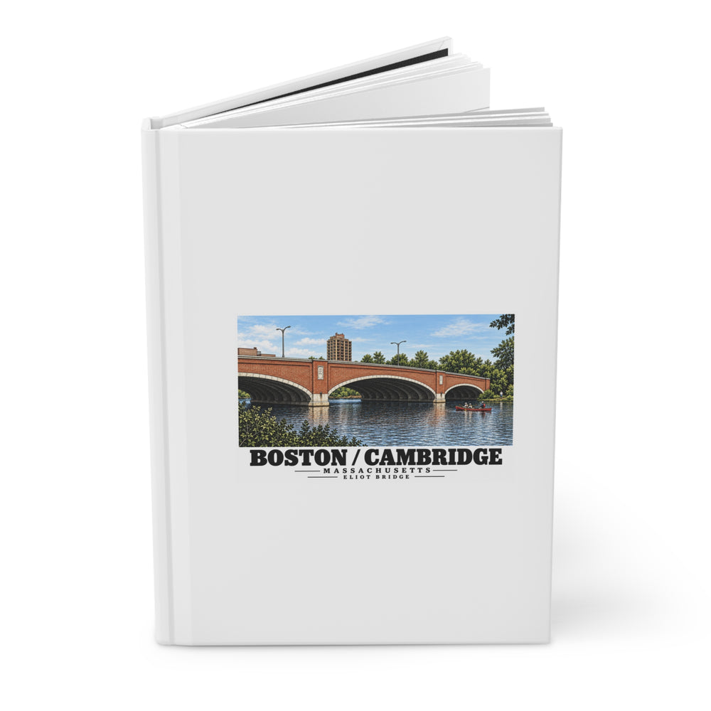 Partly opened white hardcover journal showing Eliot Bridge red brick arches and boats artwork on the front