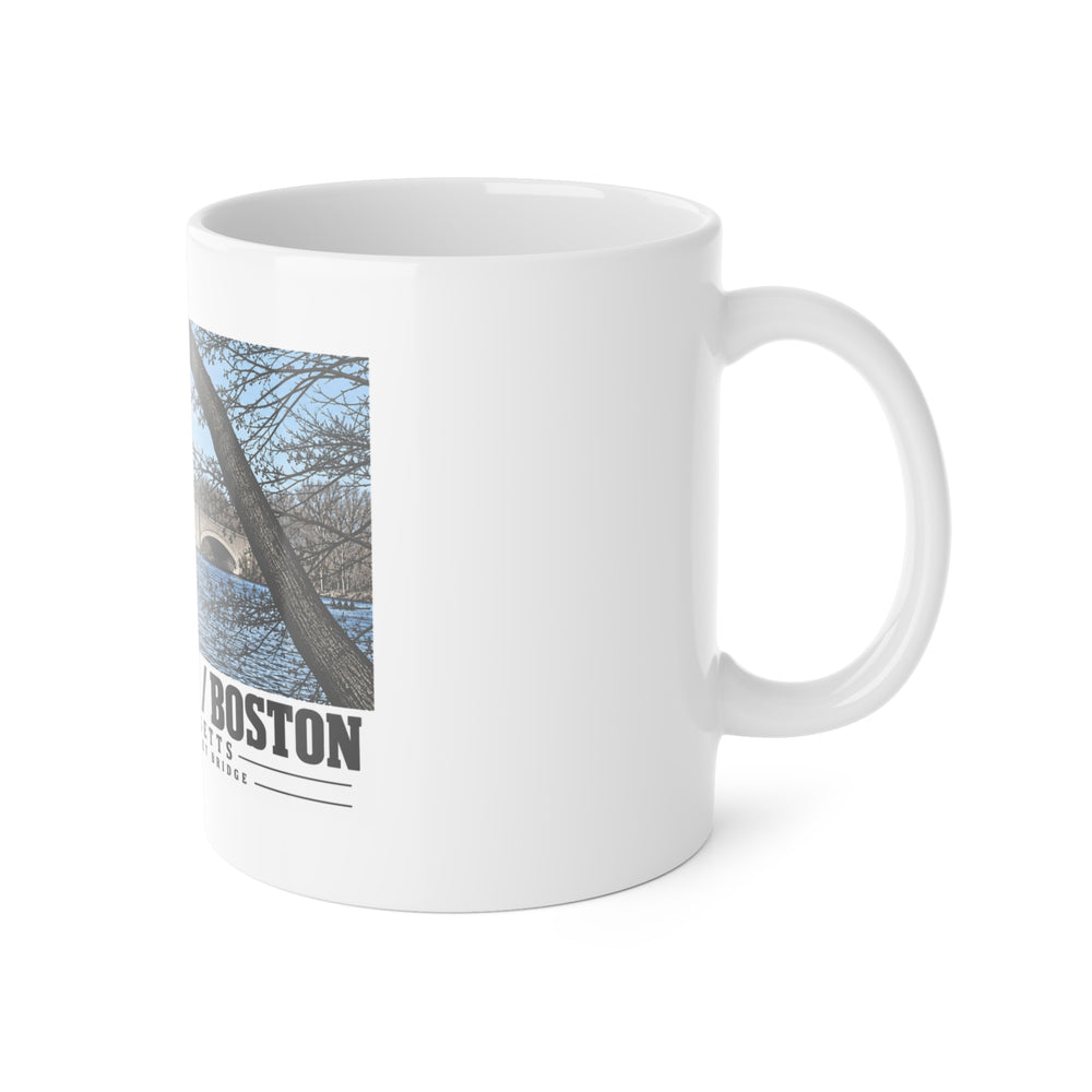 White mug with handle at right and part of the North Beacon Street Bridge stone arches framed by a bare tree print at left