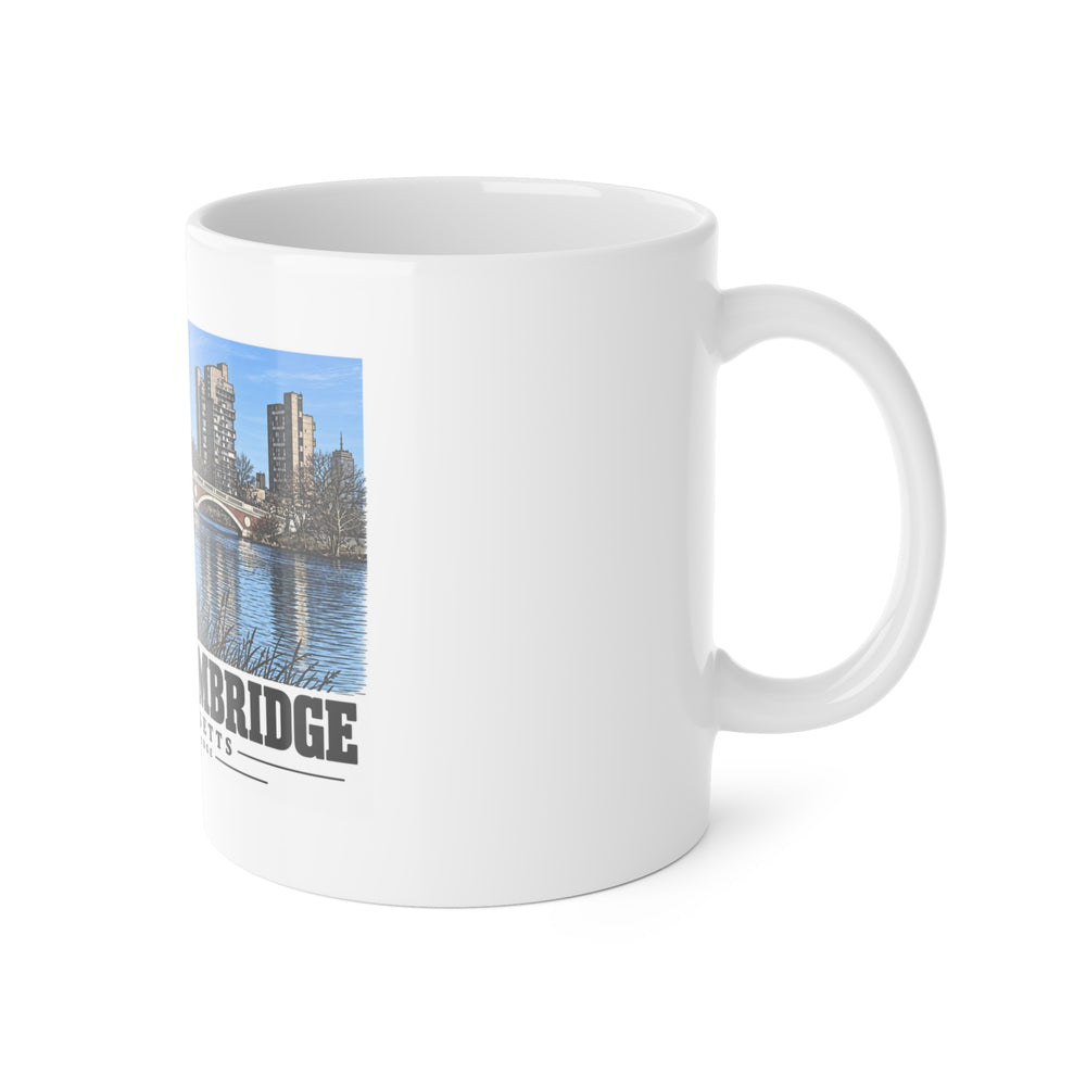 White mug with handle at right and part of the Weeks Footbridge stone arches and riverside towers print at left