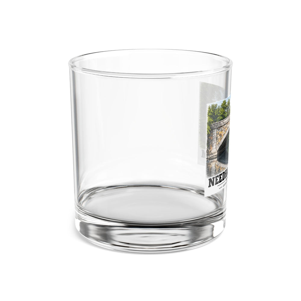 Side view of clear rocks glass with mostly unprinted surface and part of Greendale Avenue / Lyons Street Bridge stone arch and reflection print at right