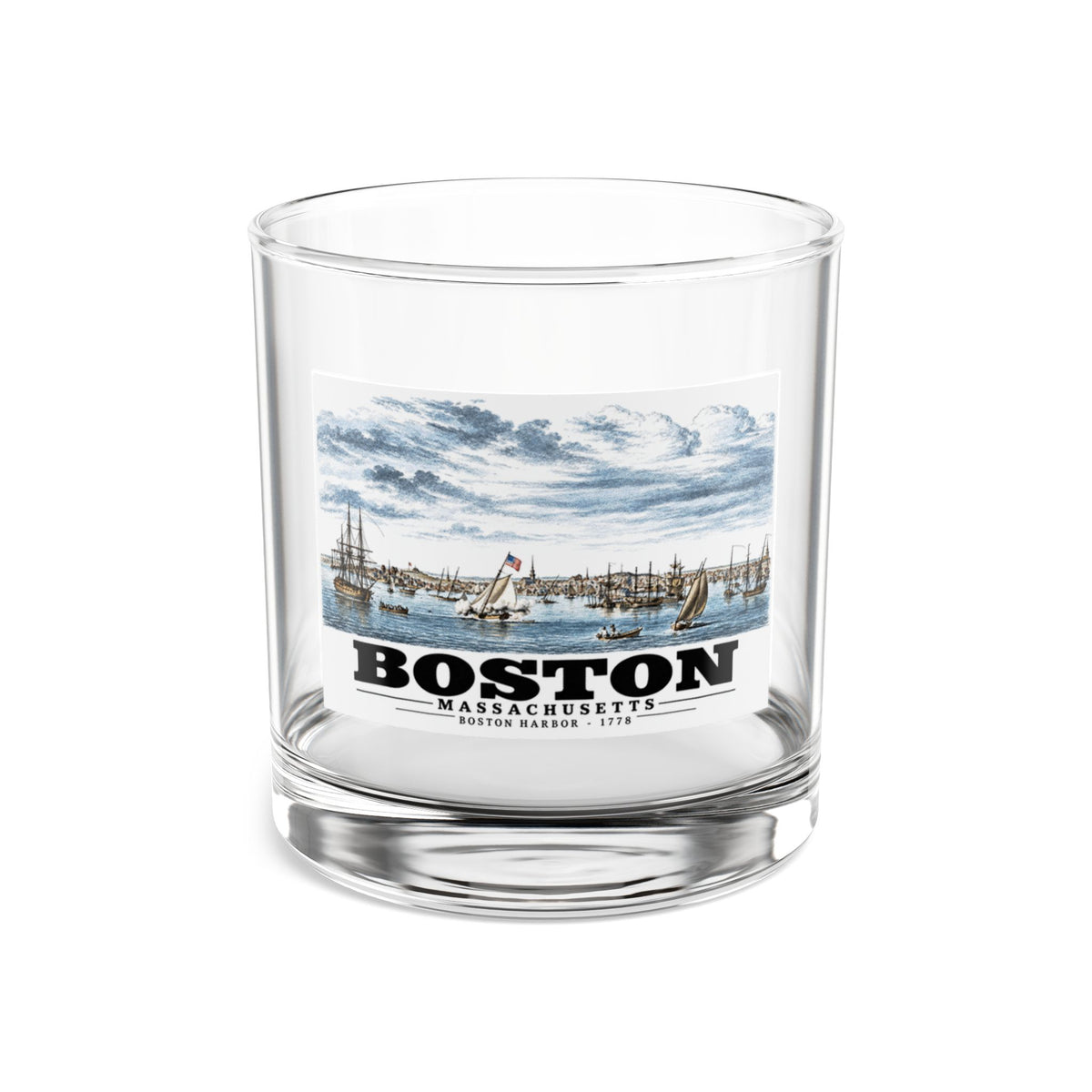 Clear rocks glass showing Boston Harbor waterfront scene with sailing ships artwork and Boston lettering
