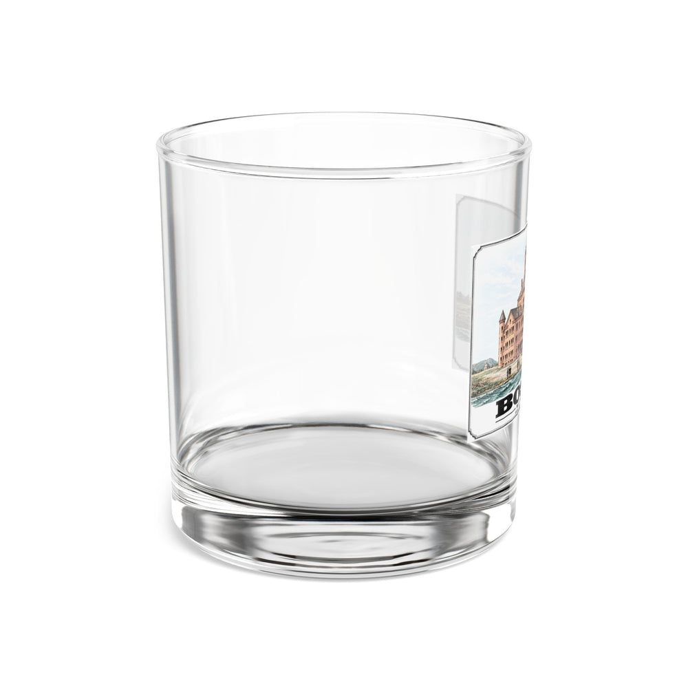 Side view of clear rocks glass with mostly unprinted surface and part of large symmetrical alms house building, grounds and figures print at right