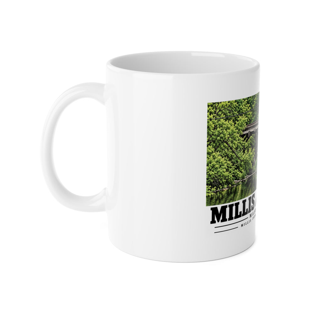 White mug with handle at left and part of the Millis Industrial Track wooden railway trestle and green foliage print at right