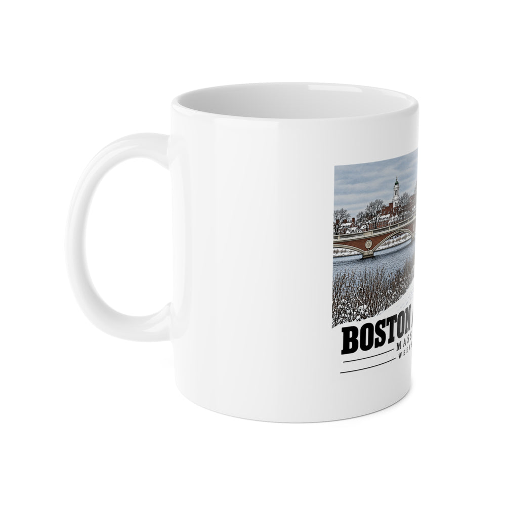 White mug with handle at left and part of the Weeks Footbridge winter riverbank view with snow and benches print at right