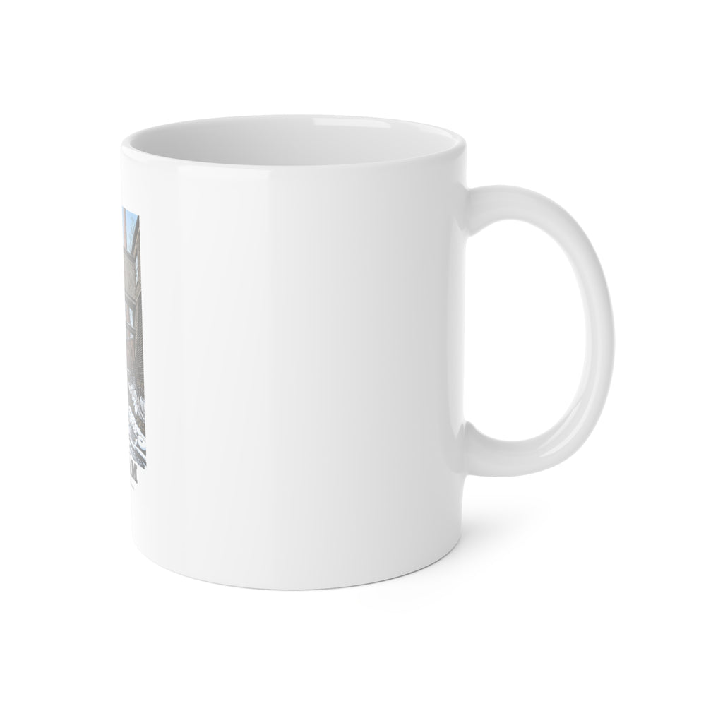 Right handle-side view of 11 oz white ceramic mug, with Norfolk Manufacturing Company Cotton Mill artwork partly visible.