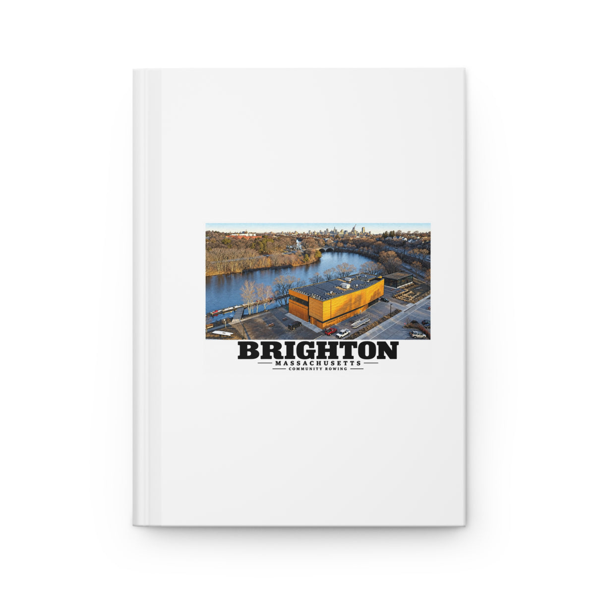 White hardcover journal with Community Rowing aerial building and river artwork and Brighton lettering