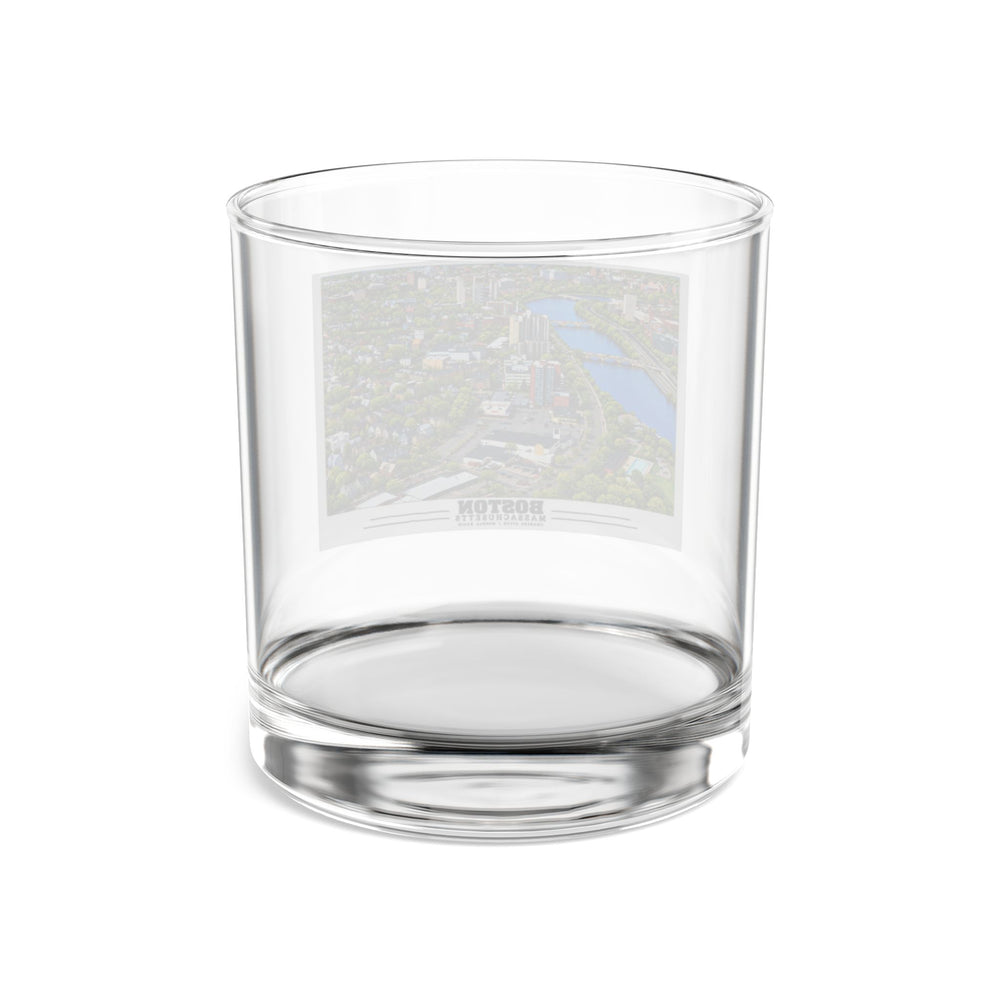 Rear view of clear rocks glass with Charles River aerial city view with bridges, buildings and green trees print and reversed lettering visible through the glass