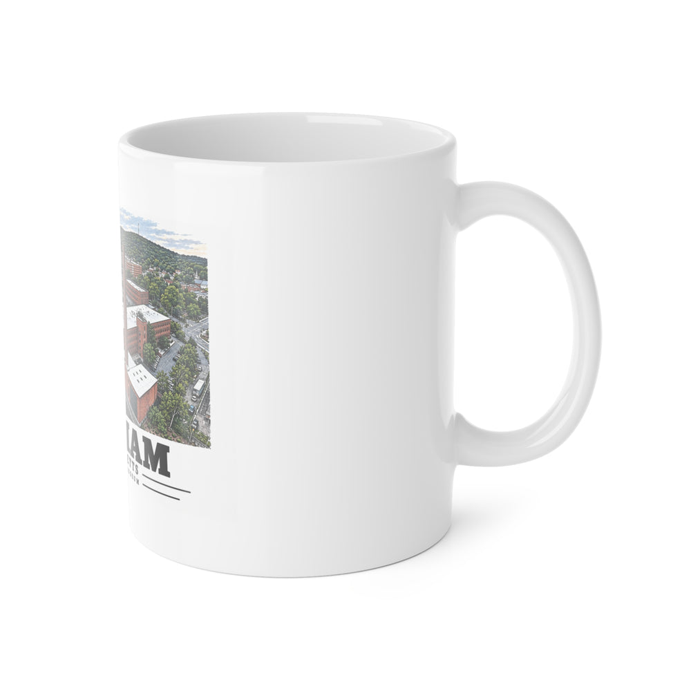 Right-handle view of the white ceramic mug with Charles River Museum artwork partly visible.