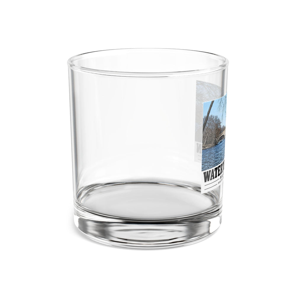 Side view of clear rocks glass with mostly unprinted surface and part of North Beacon Street Bridge stone arches framed by a bare tree print at right