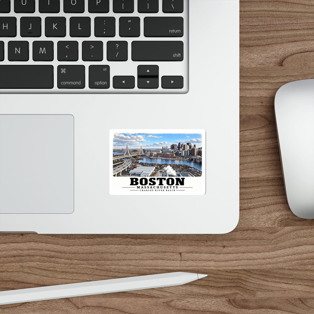 Sticker showing Boston skyline, cable-stayed bridge and Charles River basin artwork on a laptop beside its keyboard