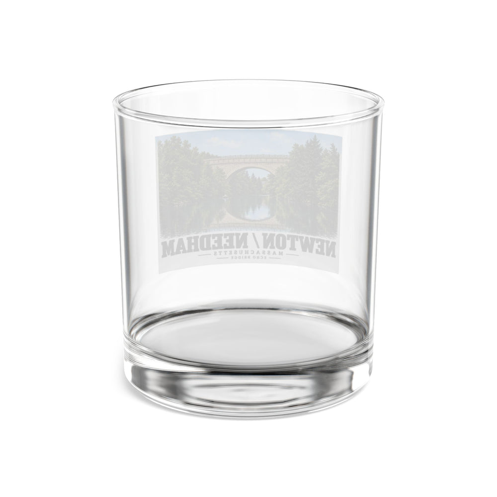 Rear view of clear rocks glass with Echo Bridge landscape print and reversed lettering visible through the glass