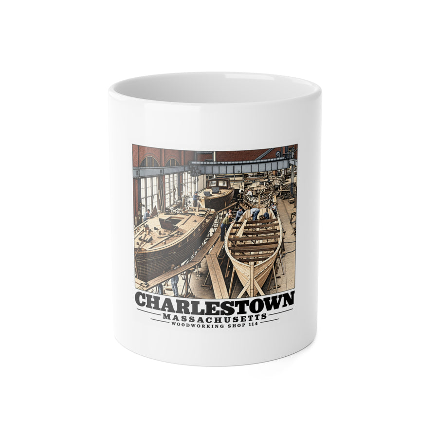 Front of white 11 oz ceramic mug with small-boat building artwork and Charlestown lettering