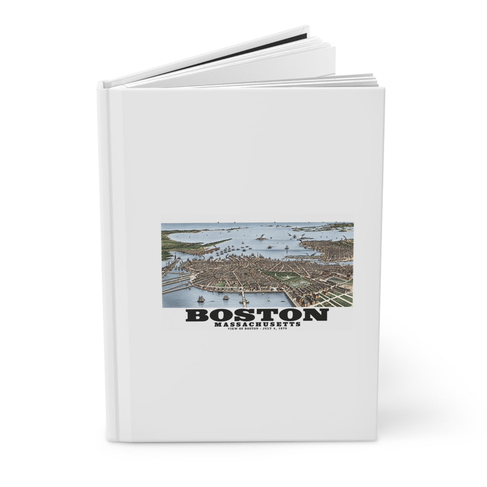 Partly opened white hardcover journal showing historic Boston harbor panorama with boats and waterfront buildings artwork on the front