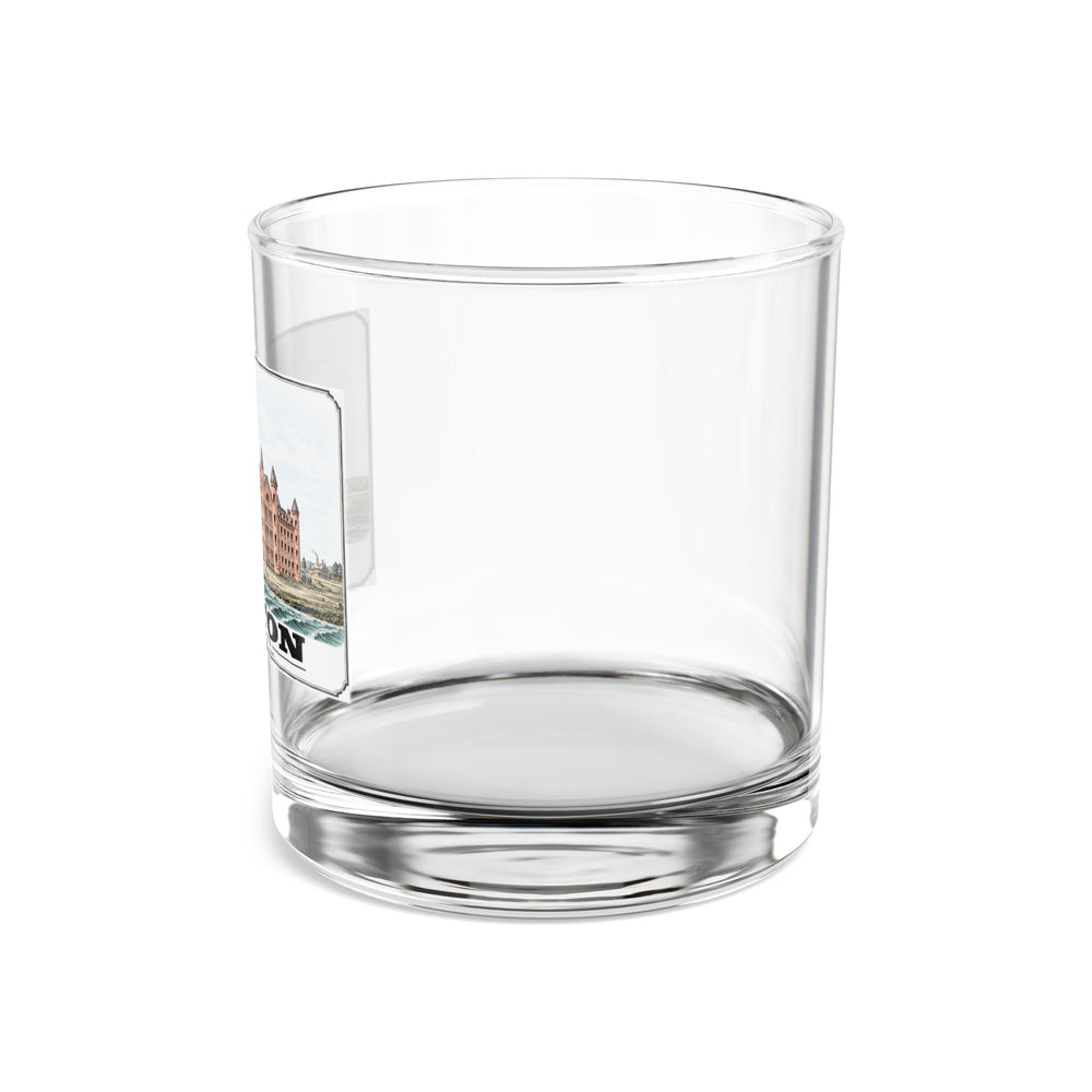 Side view of clear rocks glass with mostly unprinted surface and part of large symmetrical alms house building, grounds and figures print at left