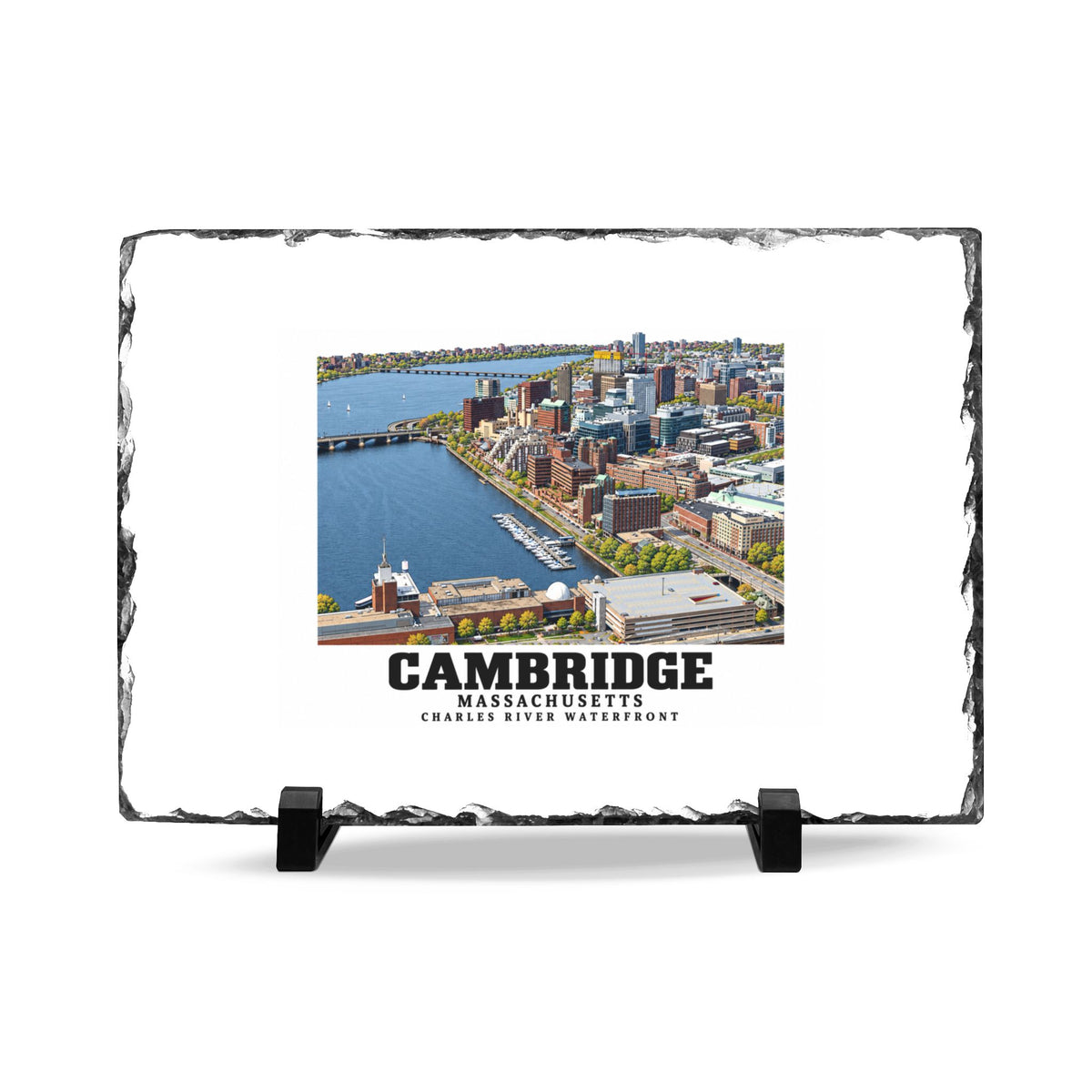 Rough-edged slate display on two black stands with Cambridge Charles River waterfront aerial city view artwork and Cambridge lettering