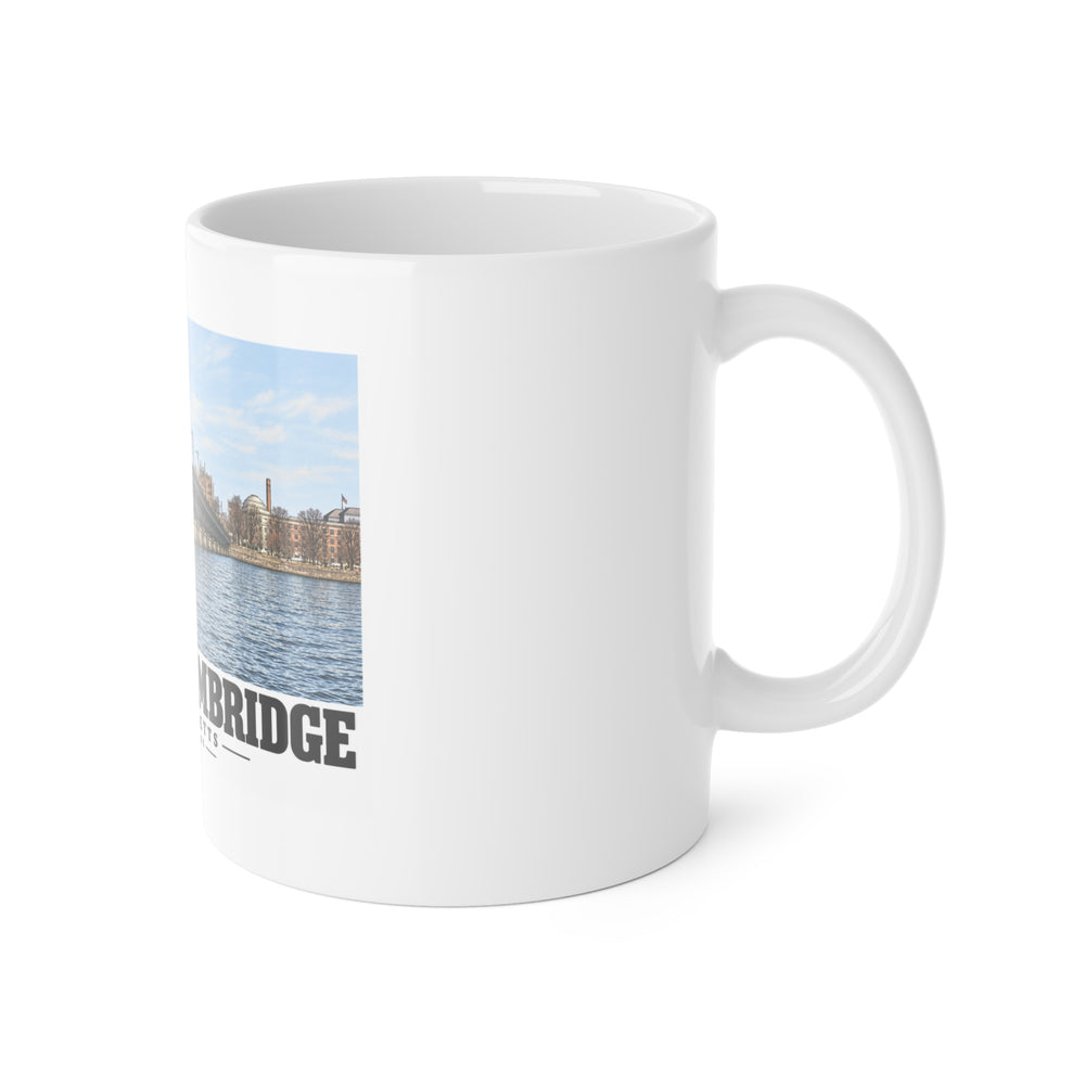 White mug with handle on the right and part of the Harvard Bridge print visible on the left