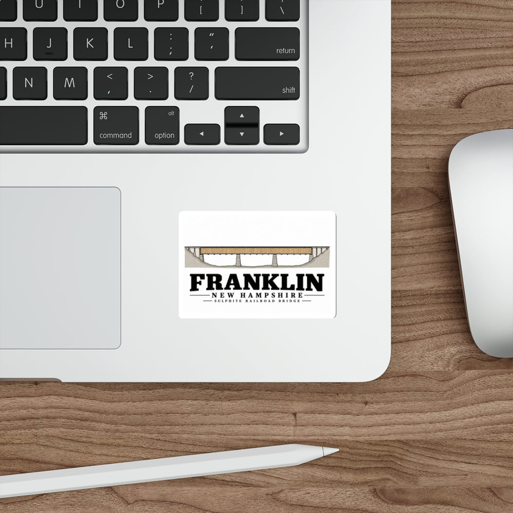Laptop display of Sulphite Railroad Bridge white die-cut sticker, with Franklin, New Hampshire artwork and lettering.