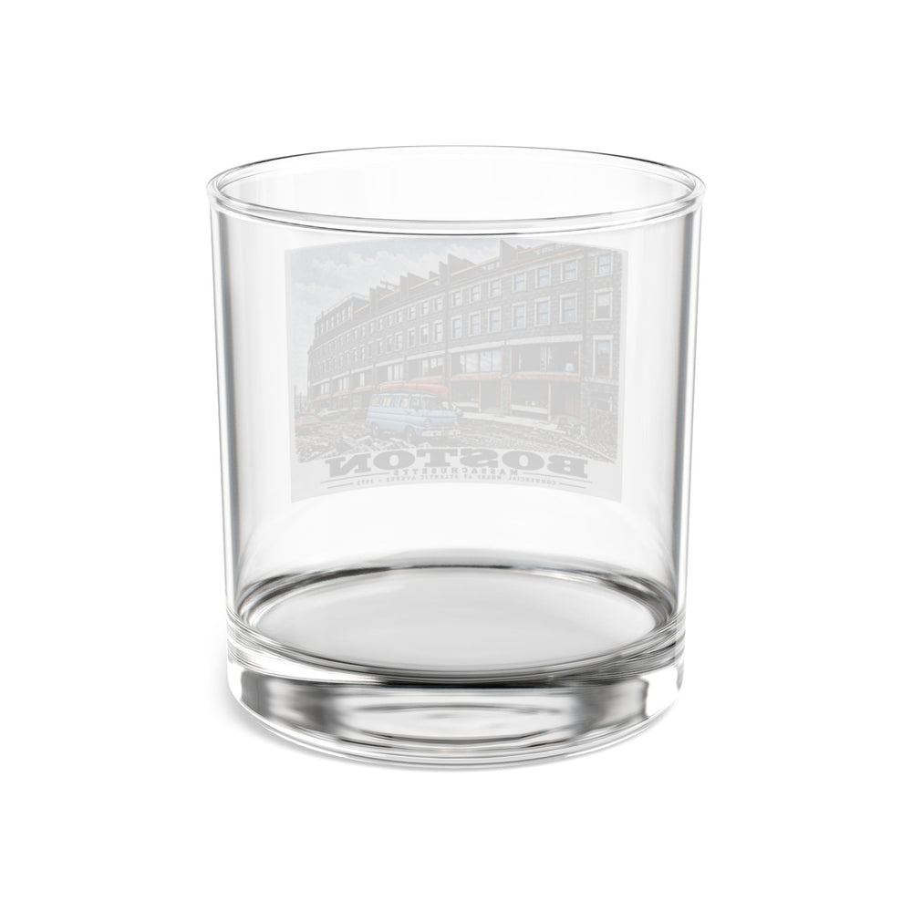Rear view of clear rocks glass with Commercial Wharf Street buildings, blue van and renovation debris print and reversed lettering visible through the glass