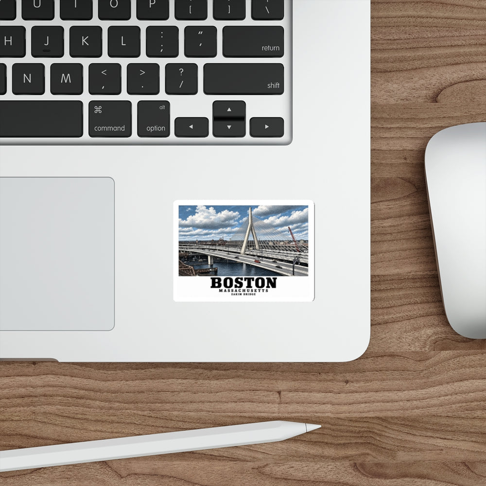 Sticker showing Zakim Bunker Hill Bridge cable-stayed towers and Charles River artwork on a laptop beside its keyboard