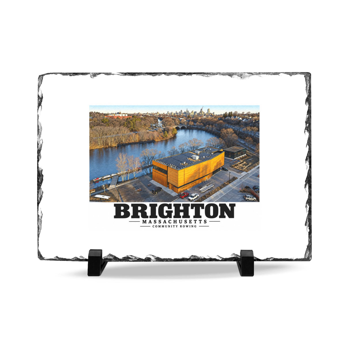 Rough-edged slate display on two black stands with Community Rowing aerial building and river artwork and Brighton lettering