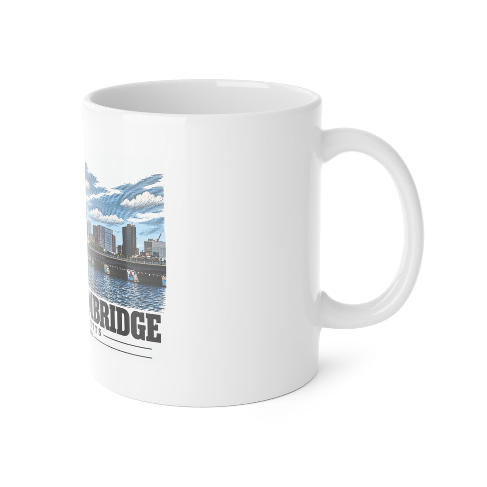 White mug with handle at right and part of the Harvard Bridge river and skyline view print at left
