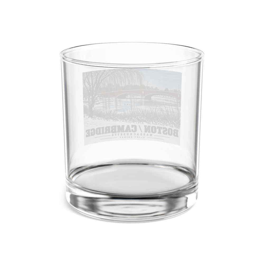 Rear view of clear rocks glass with Eliot Bridge winter river view with snow and bare trees print and reversed lettering visible through the glass