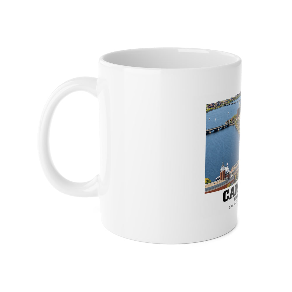 White mug with handle at left and part of the Cambridge Charles River waterfront aerial city view print at right