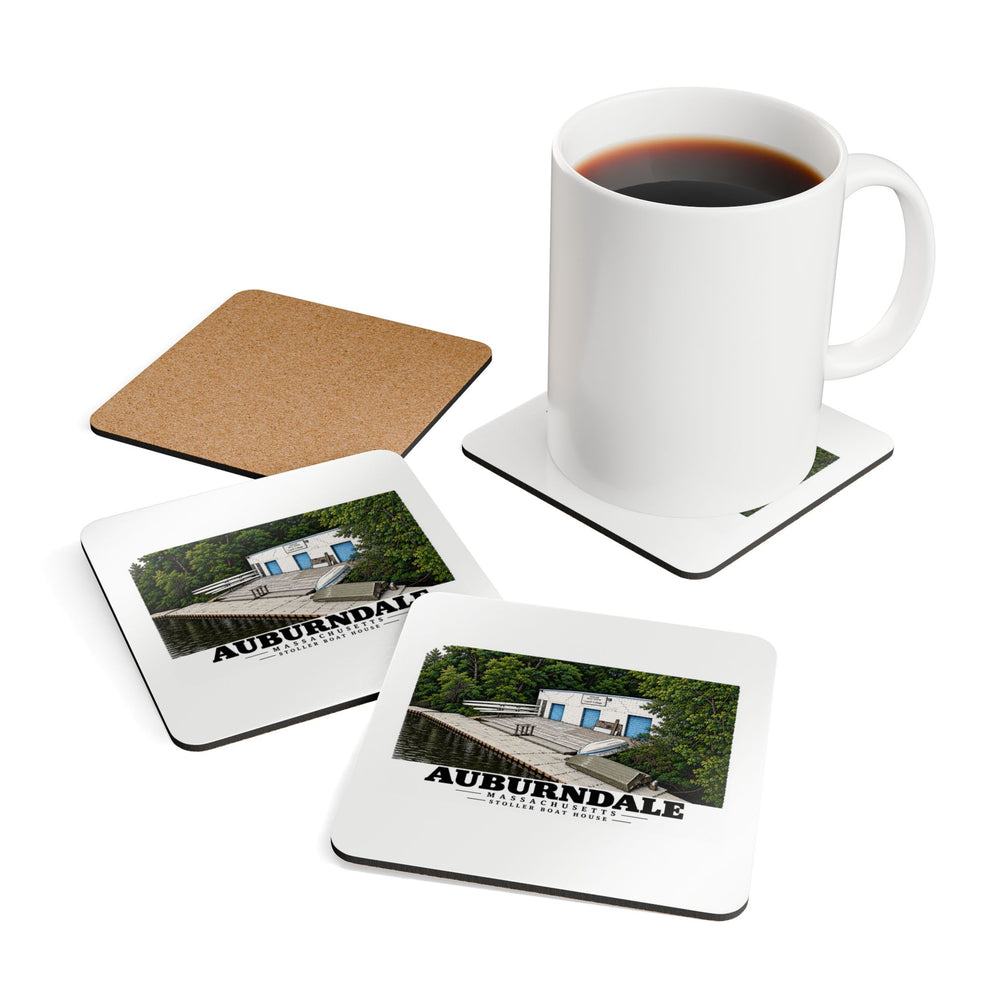 Coffee mug resting on a Stoller Boathouse coaster beside two printed coasters and an exposed cork back.