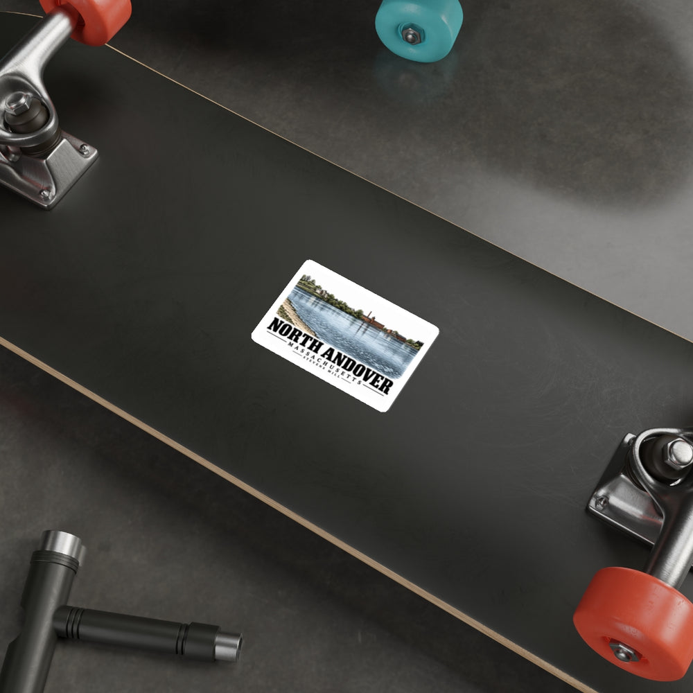 Skateboard display of Stevens Mill white die-cut sticker, with North Andover, Massachusetts artwork and lettering.