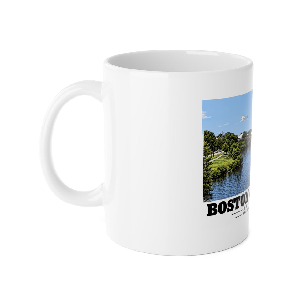 White mug with handle at left and part of the Anderson Memorial Bridge distant river view print at right