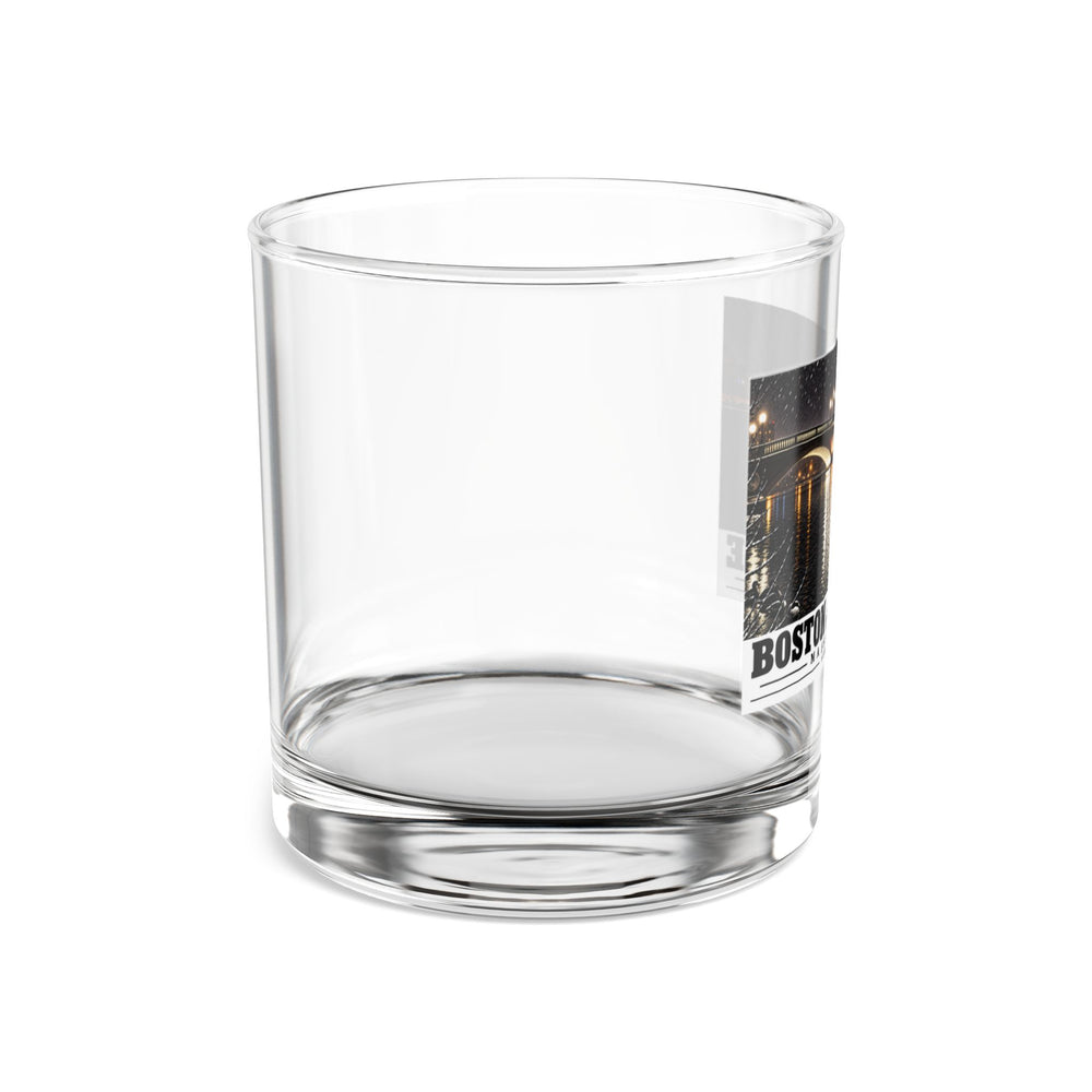 Side view of clear rocks glass with mostly unprinted surface and part of Weeks Footbridge illuminated night view with water reflections print at right