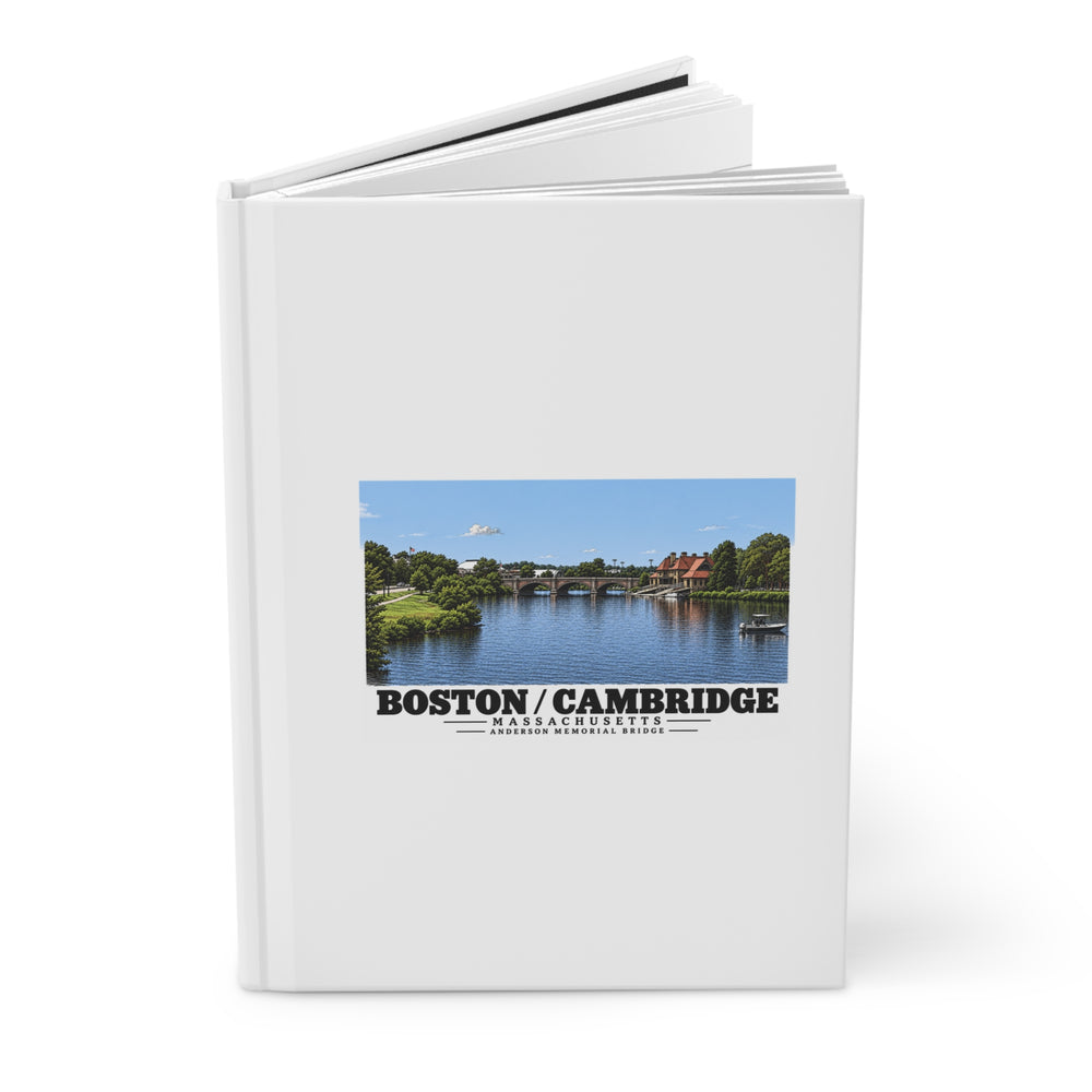 Partly opened white hardcover journal showing Anderson Memorial Bridge distant river view artwork on the front