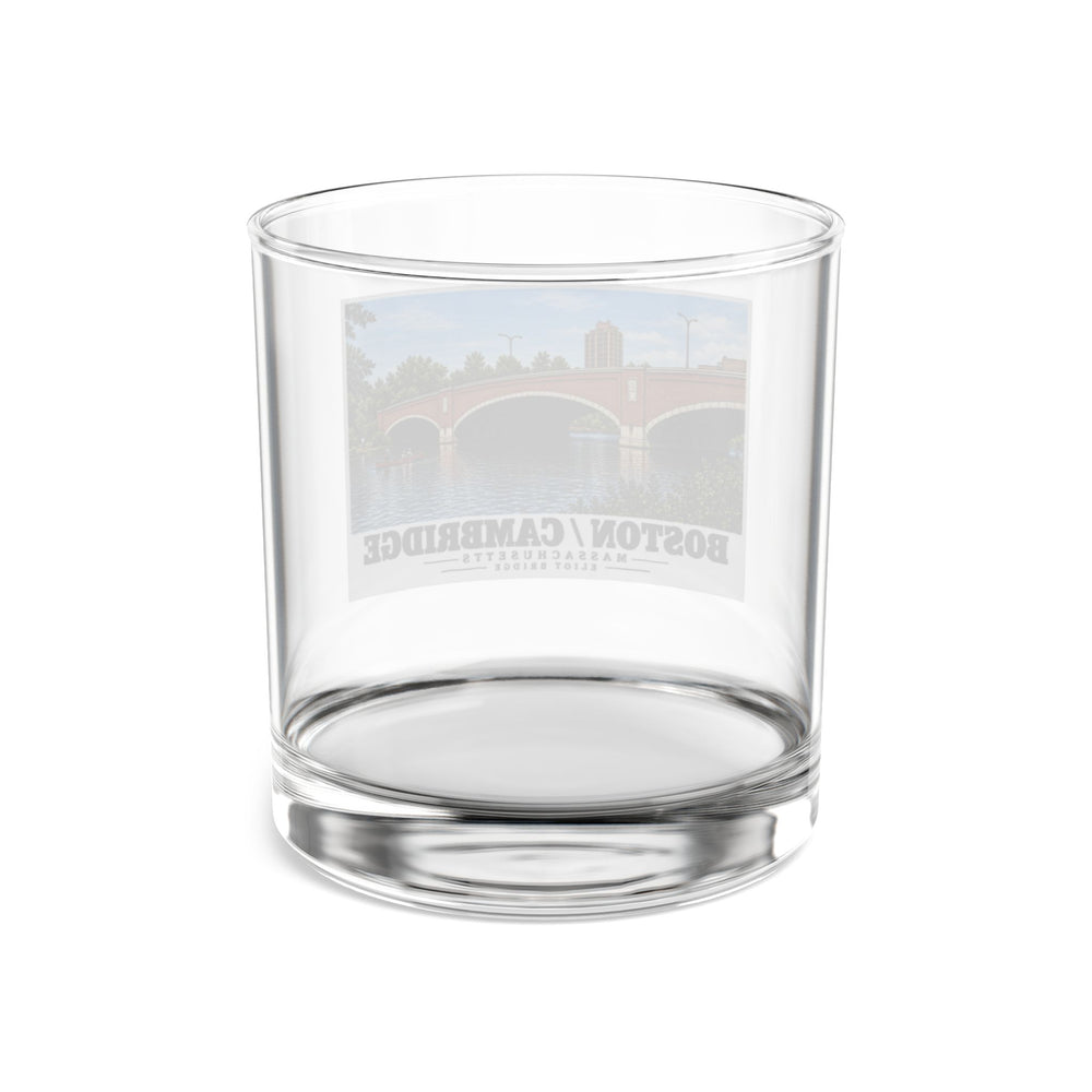 Rear view of clear rocks glass with Eliot Bridge red brick arches and boats print and reversed lettering visible through the glass