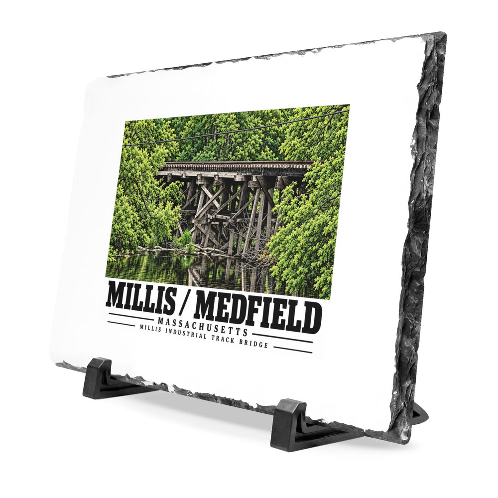 Angled rough-edged slate display on black stands showing Millis Industrial Track wooden railway trestle and green foliage artwork