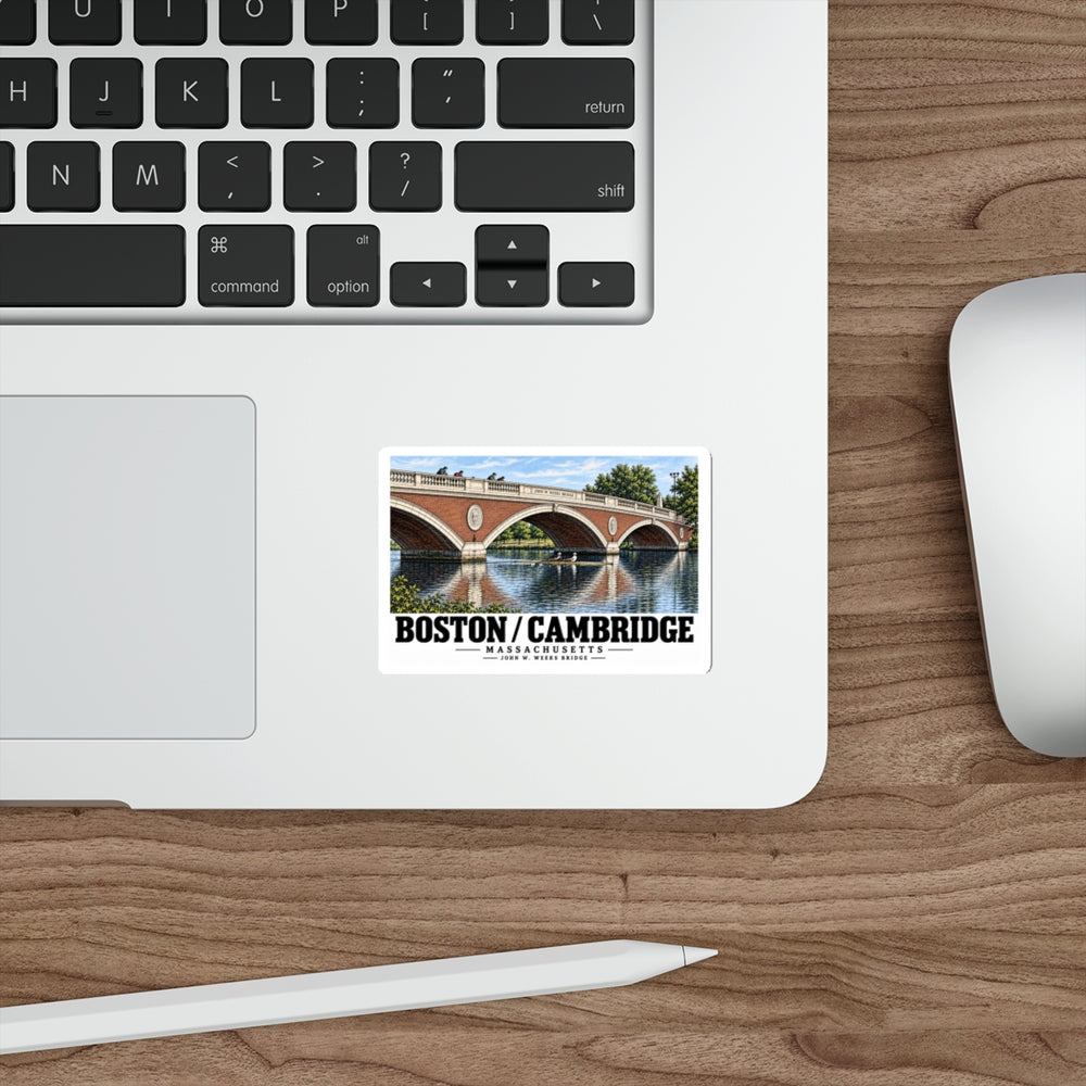 Sticker showing John W. Weeks Bridge and scullers artwork on a laptop beside its keyboard