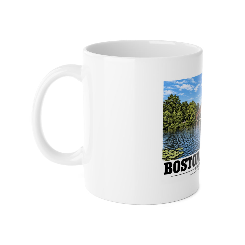 White mug with handle at left and part of the Eliot Bridge close red brick arch view print at right