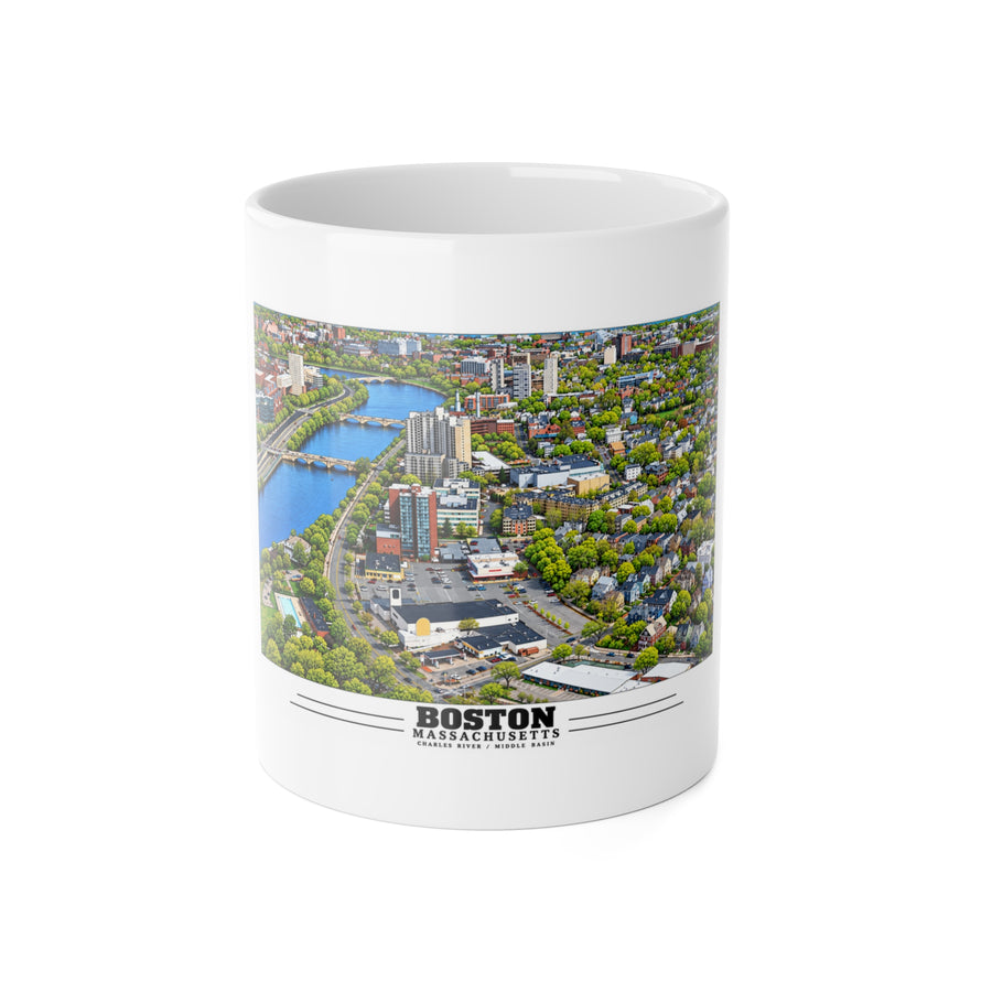 White mug showing Charles River aerial city view with bridges, buildings and green trees artwork and Boston lettering