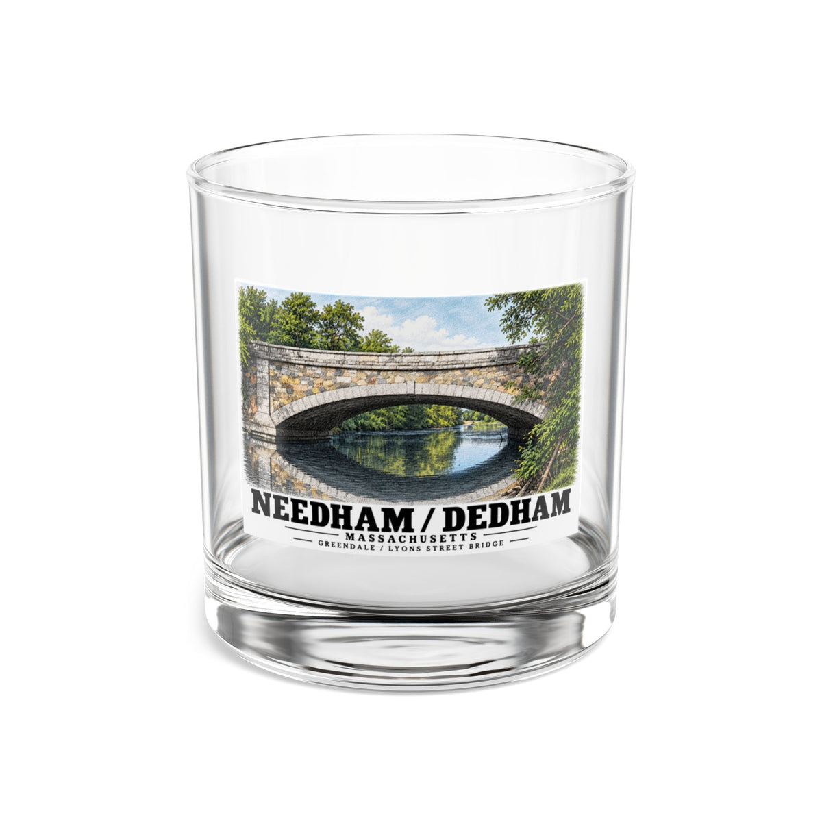 Clear rocks glass showing Greendale Avenue / Lyons Street Bridge stone arch and reflection artwork and Needham/Dedham lettering