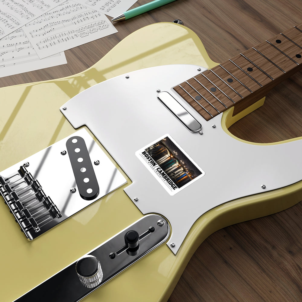 Sticker showing Weeks Footbridge illuminated night view with water reflections artwork on a pale yellow electric guitar