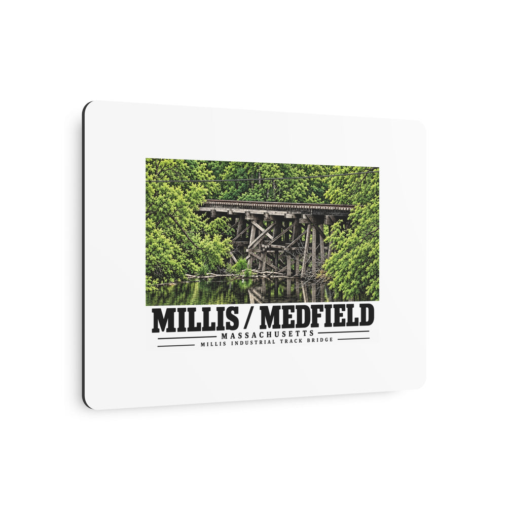 Angled view of Millis Industrial Track wooden railway trestle and green foliage metal print with its dark edge visible