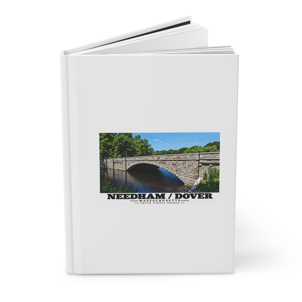 Partly opened white hardcover journal showing South Street Bridge stone arch and river artwork on the front