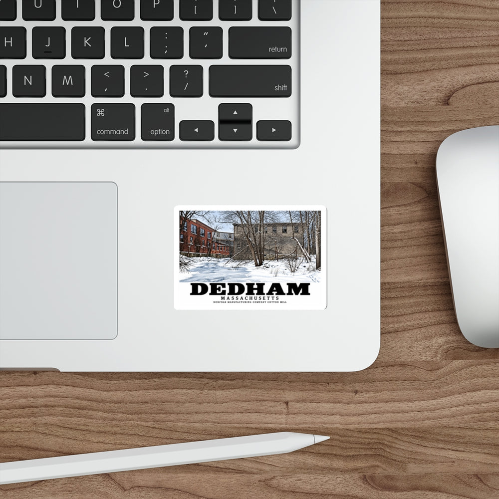 Landscape Dedham mill sticker on a laptop beside a keyboard and mouse.