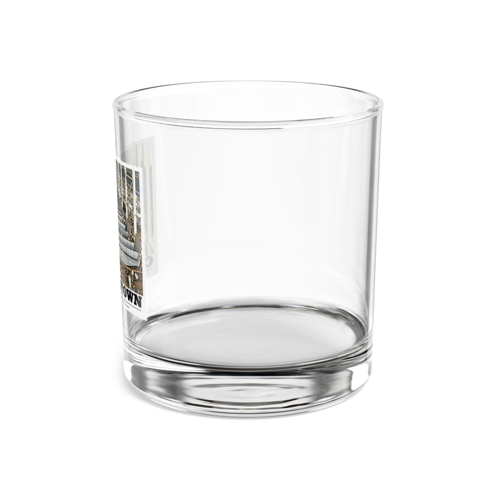 Left side of clear rocks glass showing partial landing-craft production line artwork